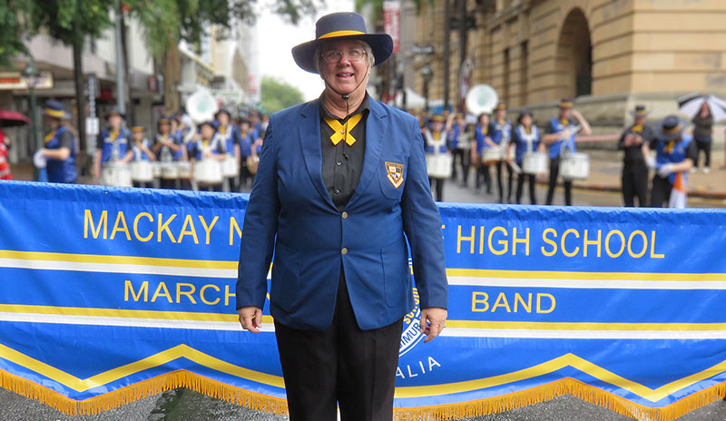 Music teacher leading a marching band.