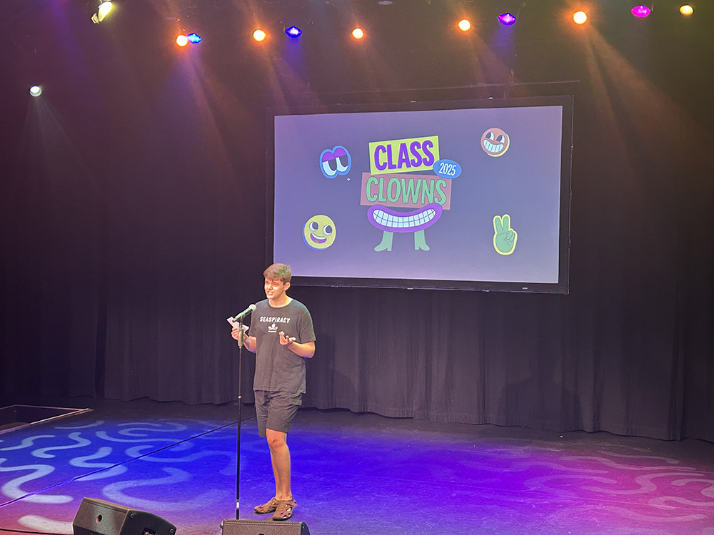 Photo of Owen talking on stage in the Class Clowns 2025 comedy club