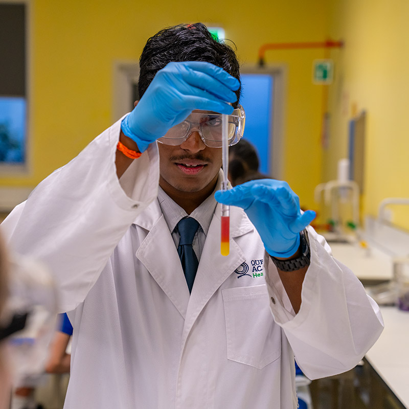 Year 11 student Pranav Nithish demonstrates how chemicals mix and react with each other