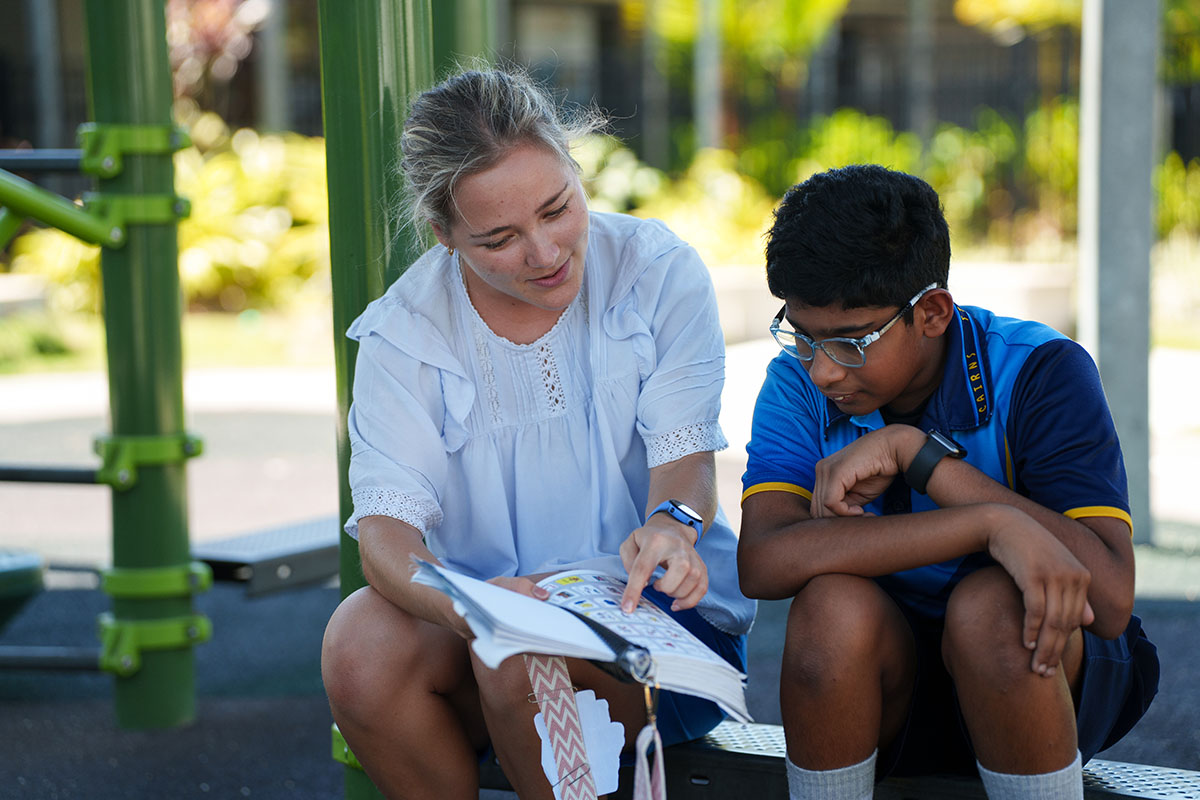 Teacher sitting with student